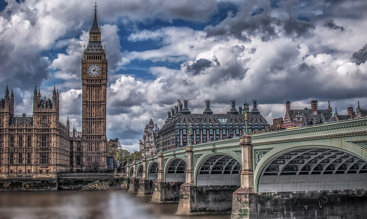 Big Ben and Westminster Bridge in London Big Ben clock tower and Westminster Bridge over River Thames in London with dramatic cloudy sky background