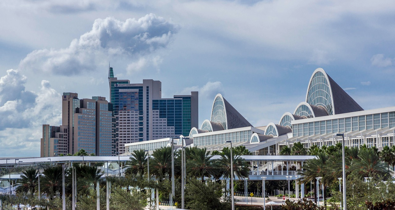 City skyline with Hyatt Regency and arched roofs Modern city skyline with Hyatt Regency hotel and unique arched roof buildings under a cloudy sky