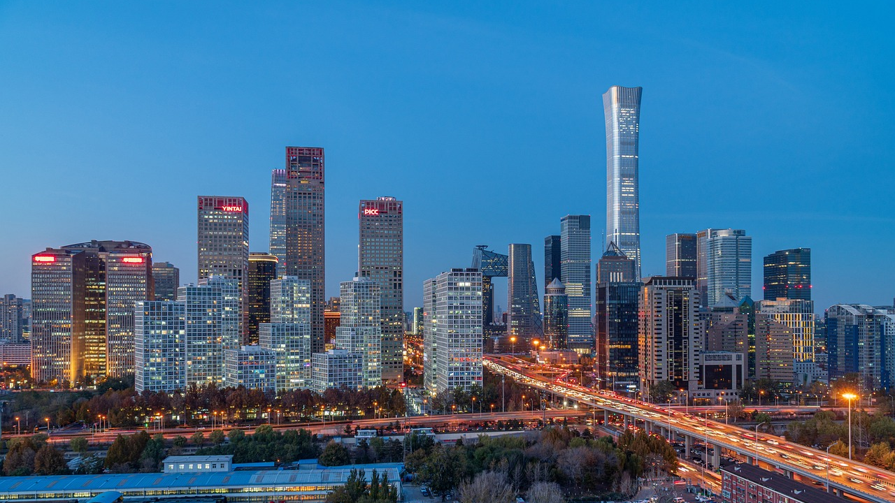 Peking - City skyline with skyscrapers and highway at twilight Peking - Modern city skyline with illuminated skyscrapers and busy highway during twilight in a metropolitan area