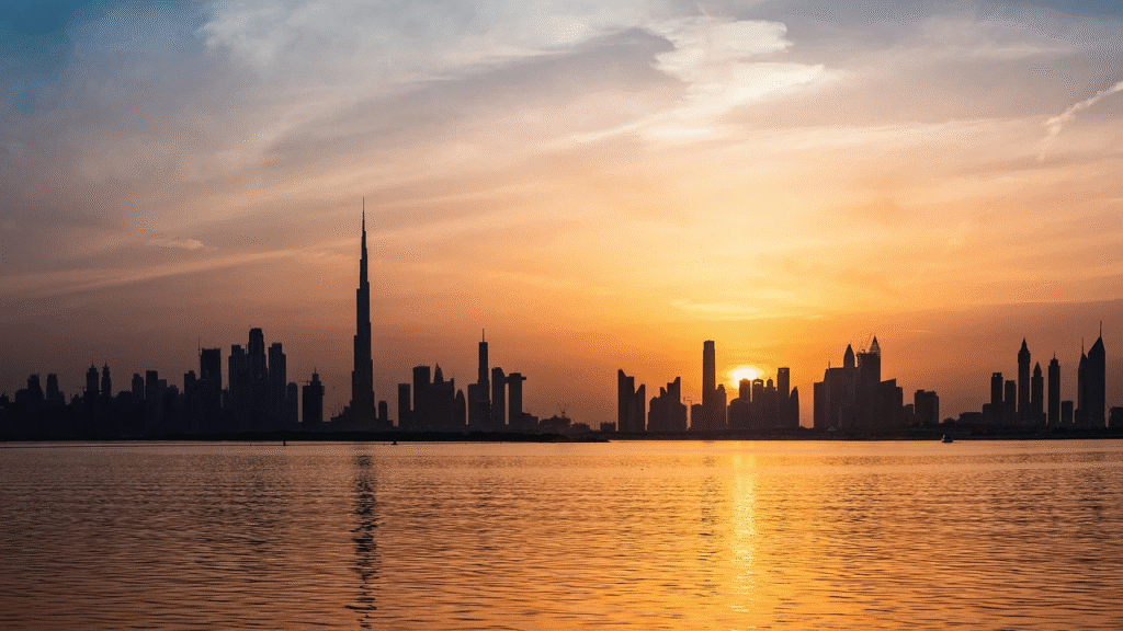 Sunset view of Dubai skyline with Burj Khalifa and modern skyscrapers reflecting on calm water in Dubai, UAE