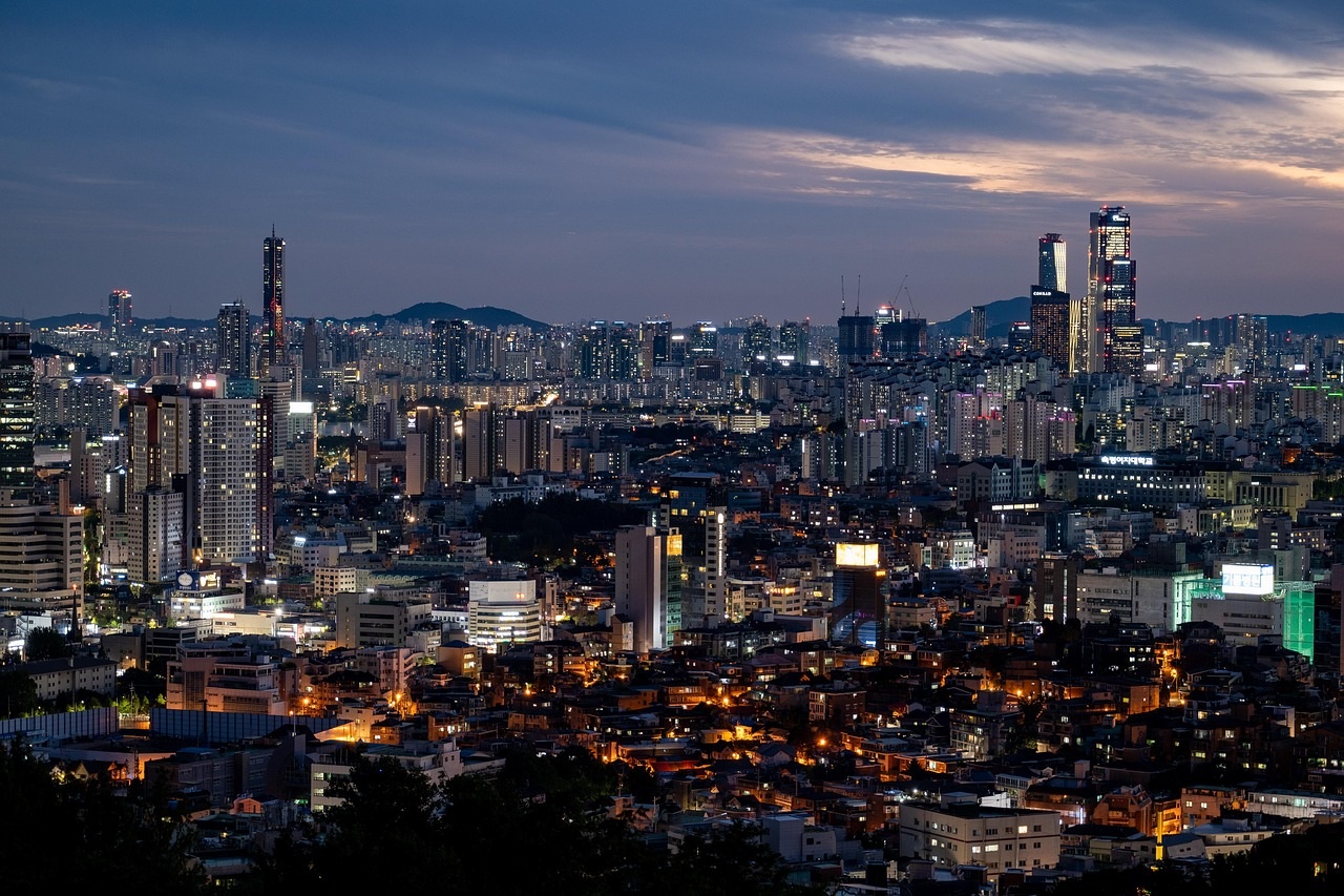Night cityscape with illuminated skyscrapers and buildings Nighttime cityscape of a densely populated urban area with illuminated skyscrapers and residential buildings