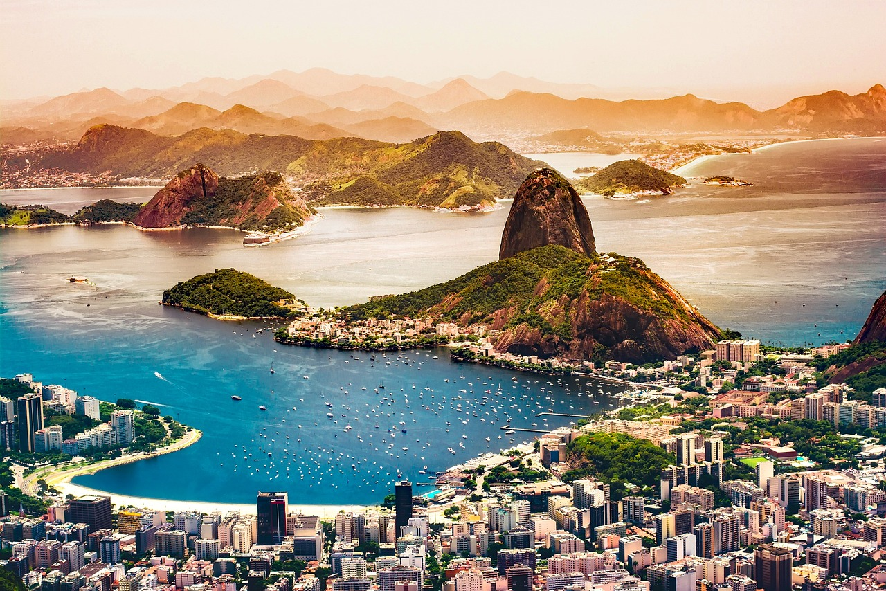 Rio de Janeiro Sugarloaf Mountain and Bay View Aerial view of Rio de Janeiro with Sugarloaf Mountain, Guanabara Bay, and cityscape under warm sunlight