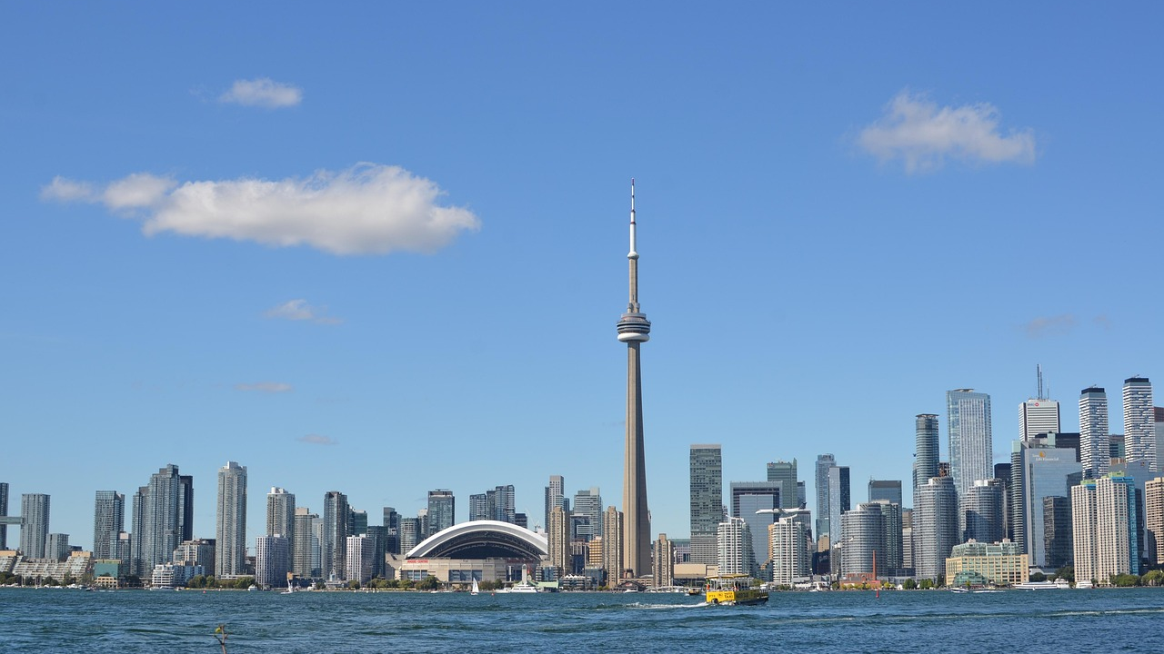 Toronto skyline with CN Tower and waterfront Toronto city skyline with CN Tower and waterfront on a clear sunny day with blue sky and scattered clouds