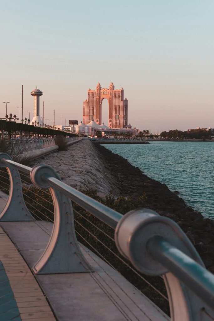 Stunning Abu Dhabi modern architecture at sunset by the waterfront — the city's deliberate post-oil-wealth transformation captured against the Persian Gulf coast