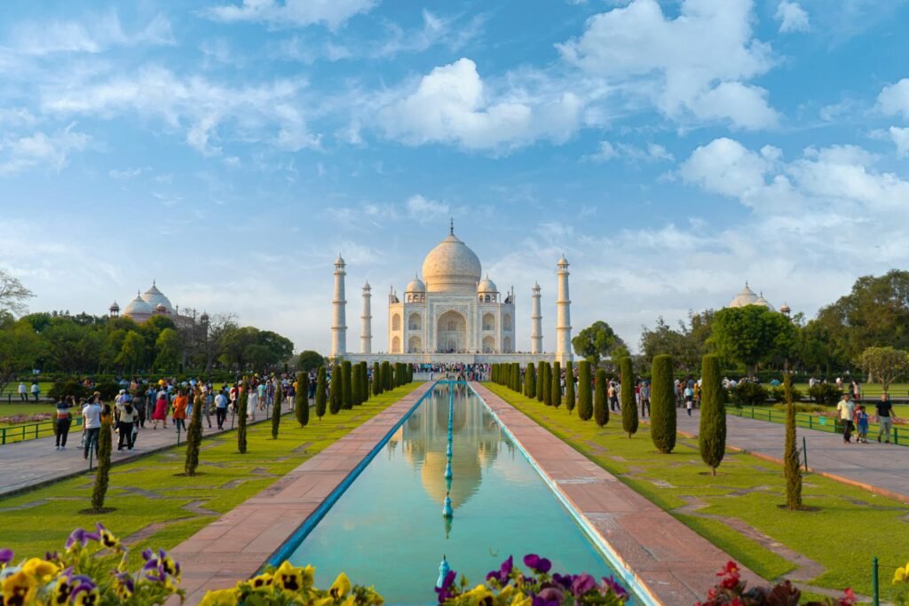 Beautiful view of the Taj Mahal in Agra against clear blue skies with the symmetrical Mughal gardens