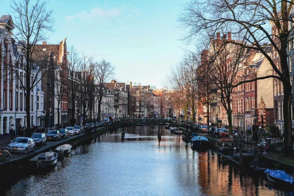 Scenic Amsterdam canal lined with historic buildings and boats, the UNESCO-listed Grachtengordel canal belt