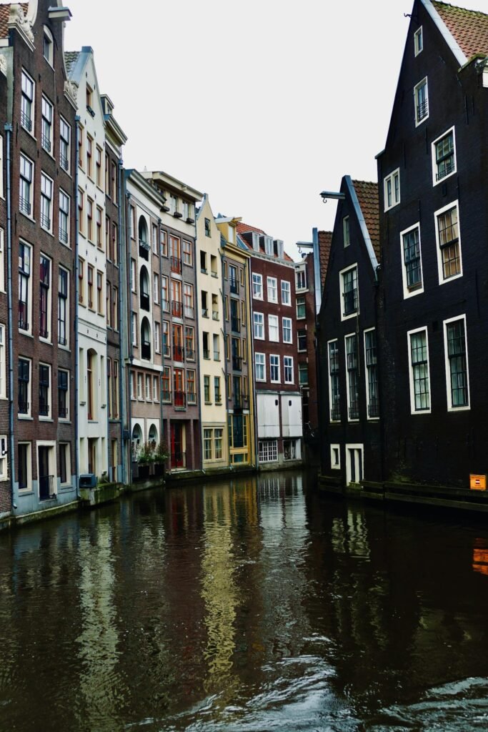Traditional gabled canal houses lining an Amsterdam canal with historic 17th-century architecture
