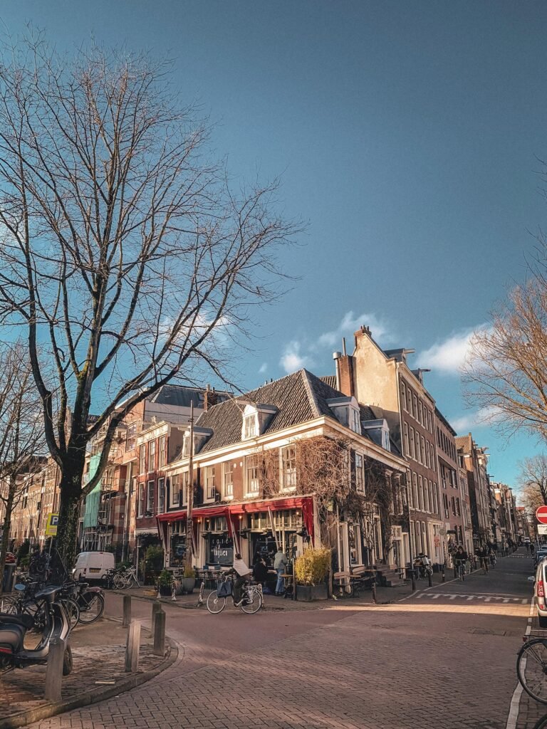 An Amsterdam streetscape with parked bicycles and traditional Dutch architecture in winter