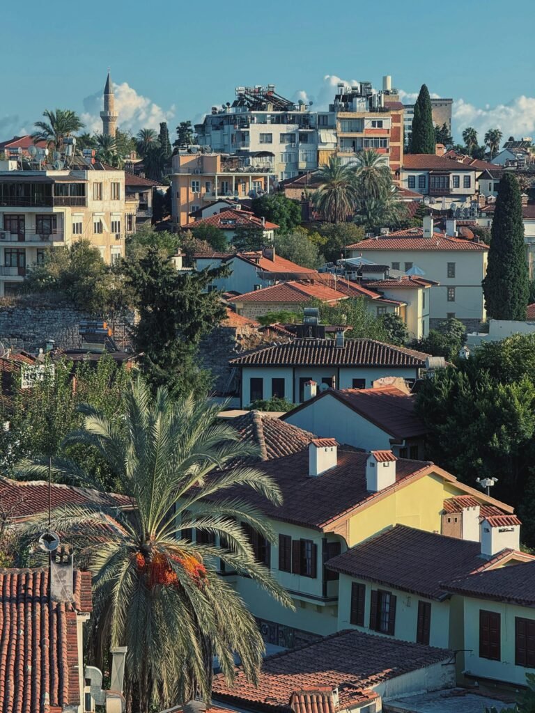 Stunning aerial view of Antalya's historic district featuring rooftops, lush greenery, and Mediterranean views