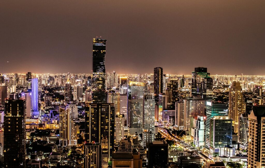 The modern Bangkok skyline at night with illuminated skyscrapers showing the city's economic scale