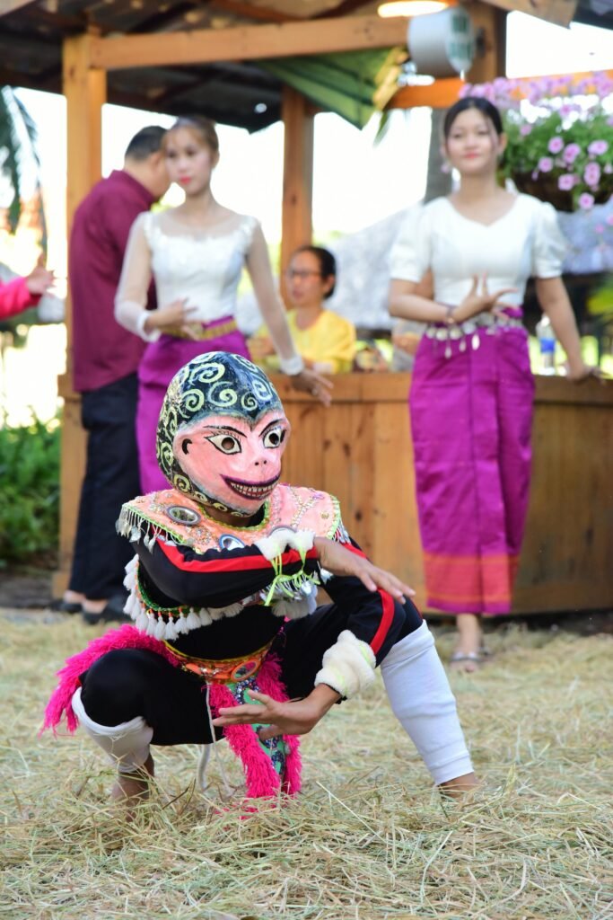 A traditional Thai Khon masked dancer in elaborate cultural attire performing classical Thai dance