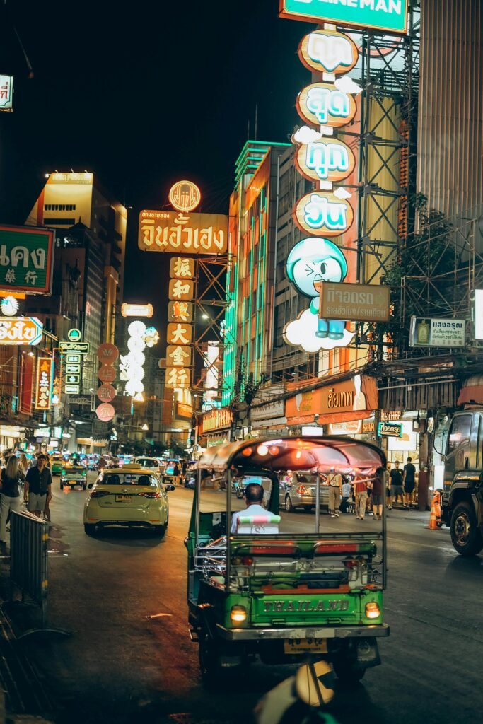 Yaowarat Road in Bangkok's Chinatown at night with colorful Chinese neon signs and bustling street activity