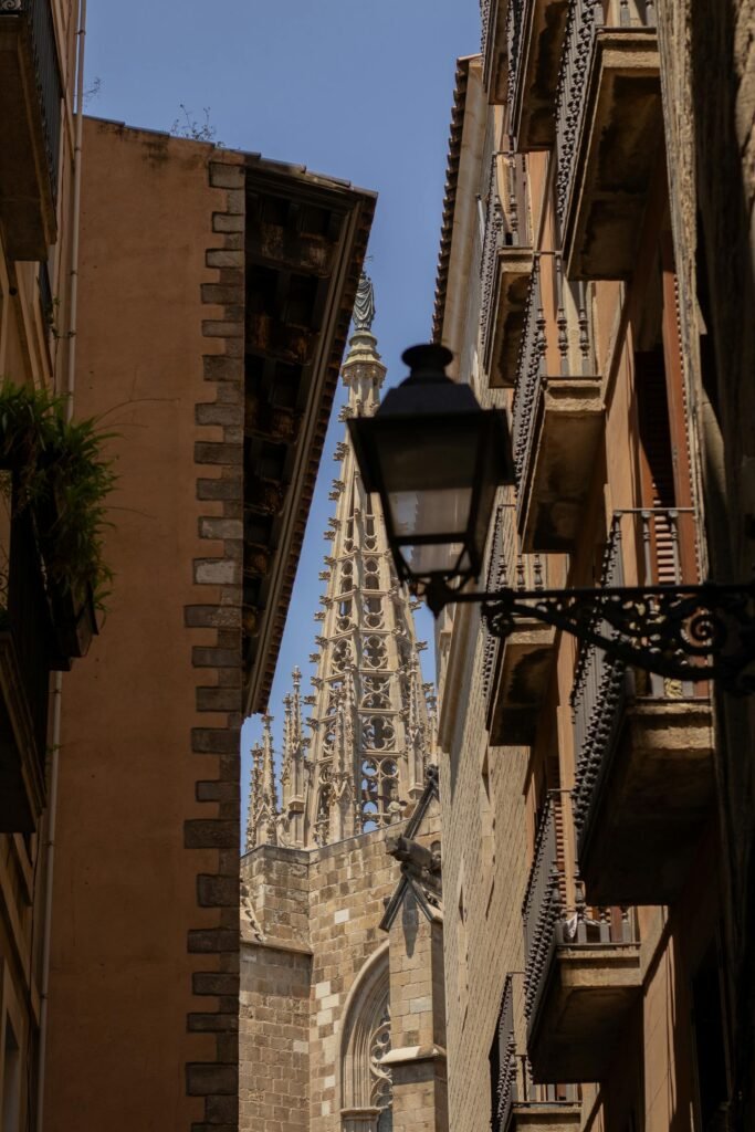 View of Barcelona Gothic Cathedral spire through the narrow streets of the Gothic Quarter