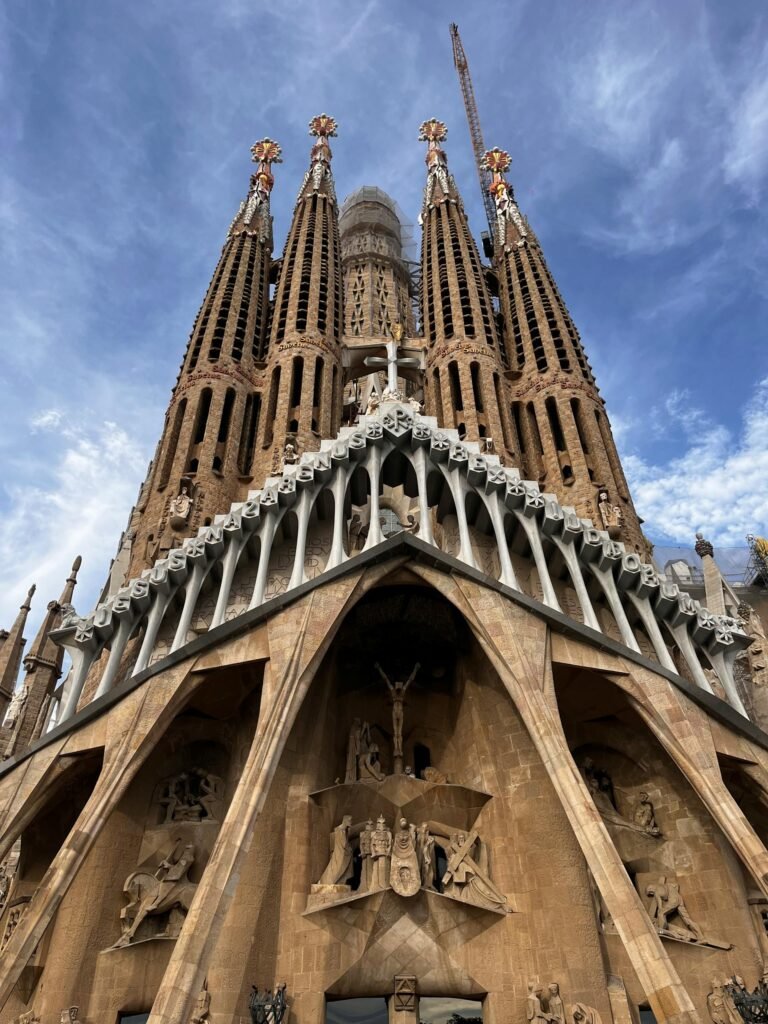 The Sagrada Família basilica rising above Barcelona's cityscape under bright blue sky