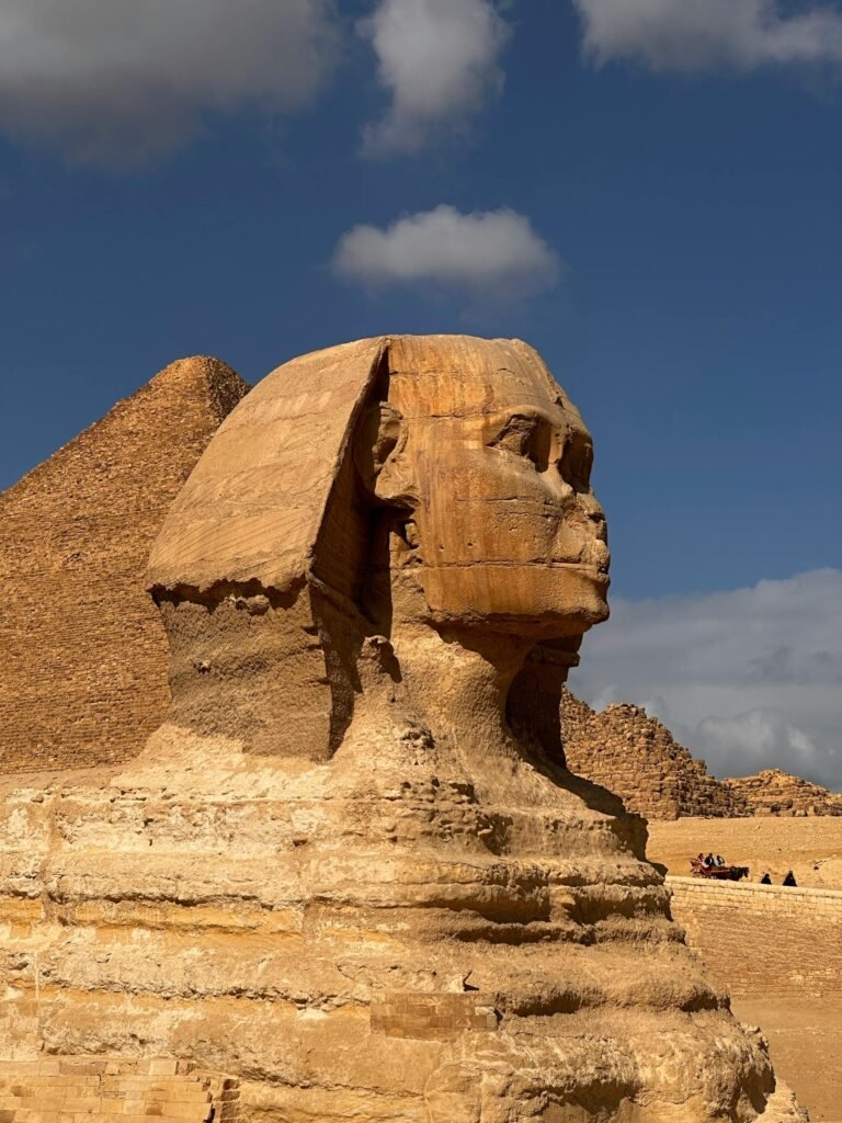 The Great Sphinx of Giza in profile with the Pyramid of Khafre rising behind, on the desert plateau outside Cairo, Egypt