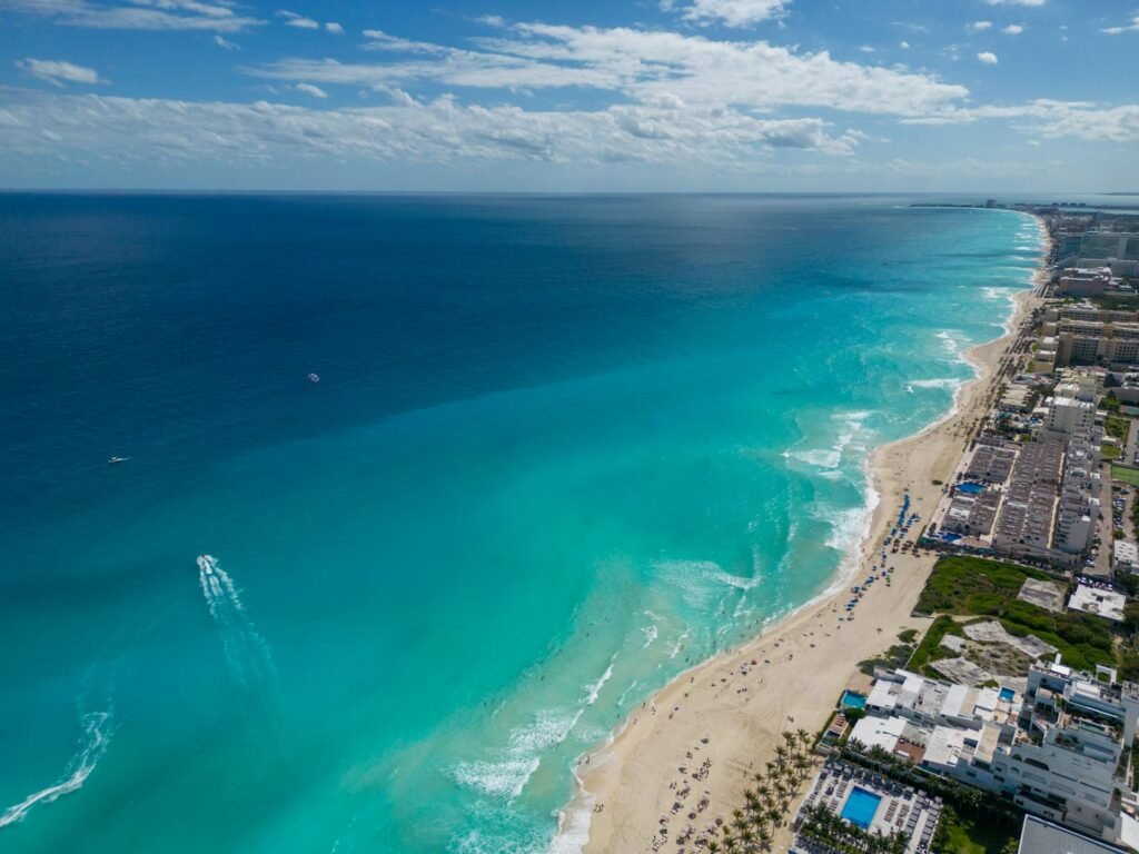Breathtaking aerial view of Cancun's turquoise waters and white-sand beaches lined with hotels
