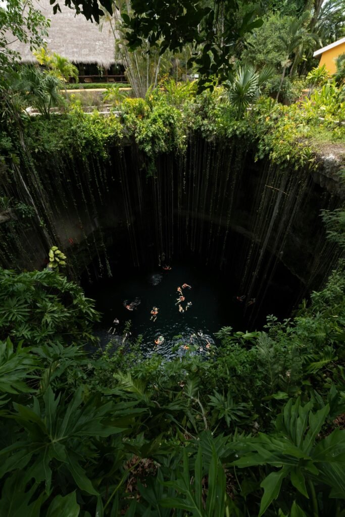Lush greenery and turquoise waters of Cenote Ik Kil in the Yucatán Peninsula near Cancún