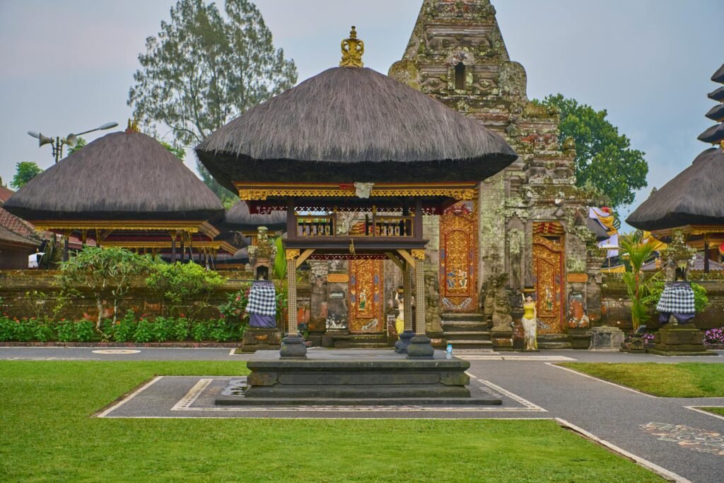 Stunning Balinese Hindu temple featuring traditional thatched roofs and intricate carvings — Bali's distinctive religious architecture