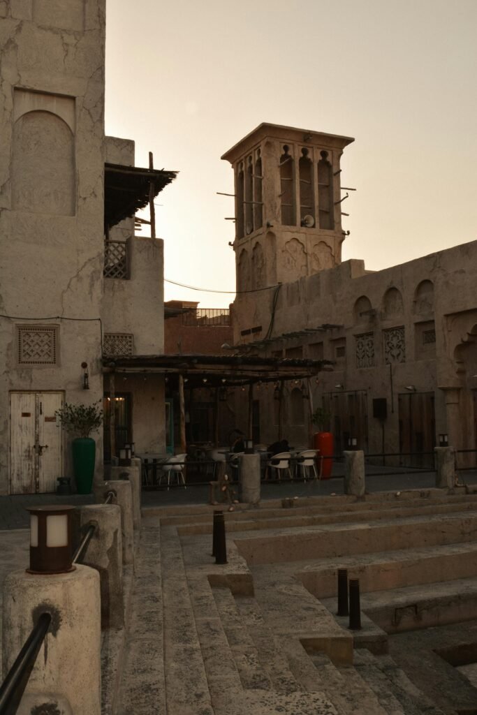 The Al Fahidi Historic District in Dubai at twilight, showcasing traditional wind-tower architecture and restored heritage buildings