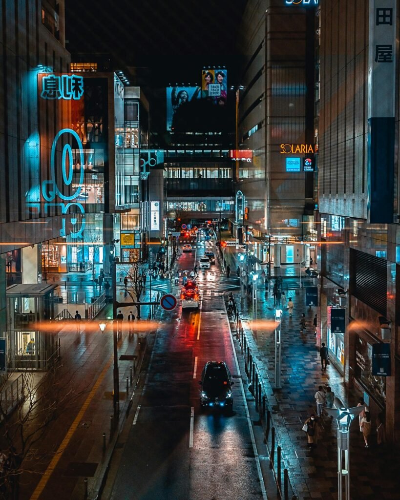 Illuminated urban street in Fukuoka City showcasing the nightlife — the city's distinctive yatai food-stall culture comes alive along the Naka River and in Tenjin after dark