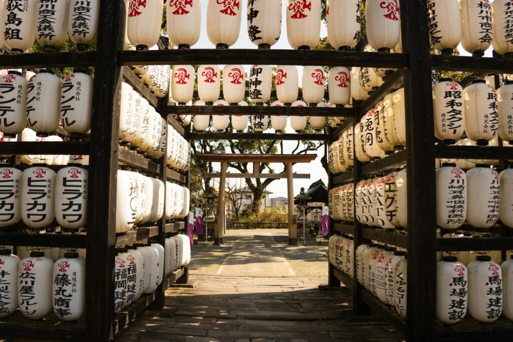 White paper lanterns at a Fukuoka shrine under a clear sky — the traditional Shinto religious atmosphere that anchors the city's cultural identity and historic festivals like the Hakata Gion Yamakasa