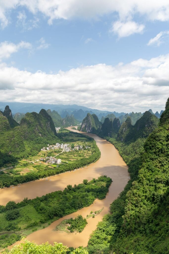 Aerial view of the Li River meandering through lush karst mountains in Guilin — the iconic landscape that has inspired Chinese poetry, painting, and the country's 20 yuan banknote for over 1,200 years