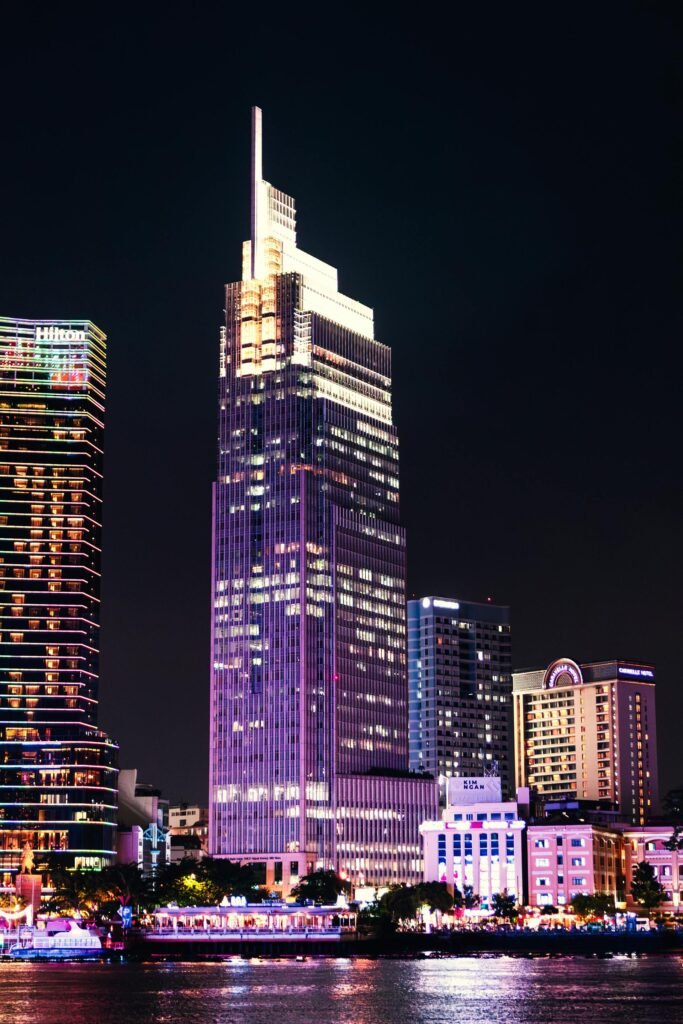 Illuminated skyscrapers in Ho Chi Minh City reflecting on the Saigon River at night