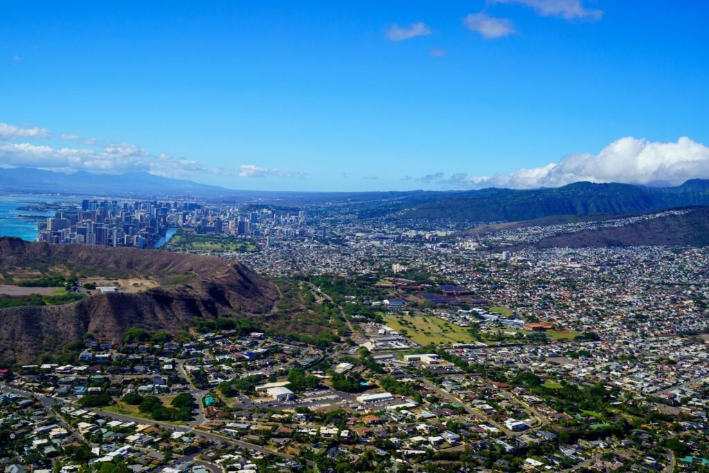 Aerial view of Honolulu showing the iconic Diamond Head volcanic crater rising at the eastern end of the city — the defining natural landmark of the Hawaiian state capital