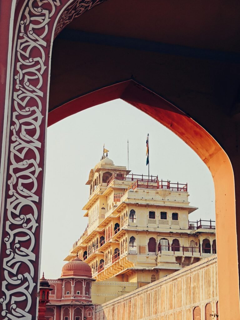Historic City Palace in Jaipur framed by intricate sandstone archways — Rajput-Mughal architectural fusion