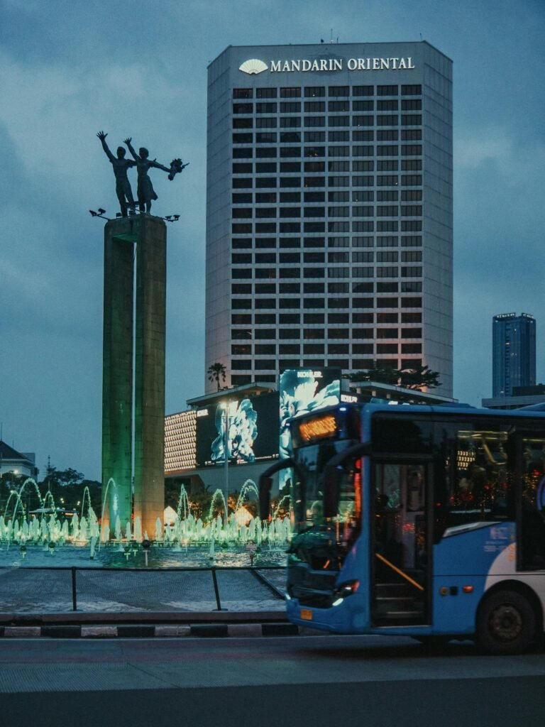 Night view of the Hotel Indonesia Roundabout (Bundaran HI) in central Jakarta — the iconic Welcome Statue (Patung Selamat Datang) at the symbolic center of modern Jakarta