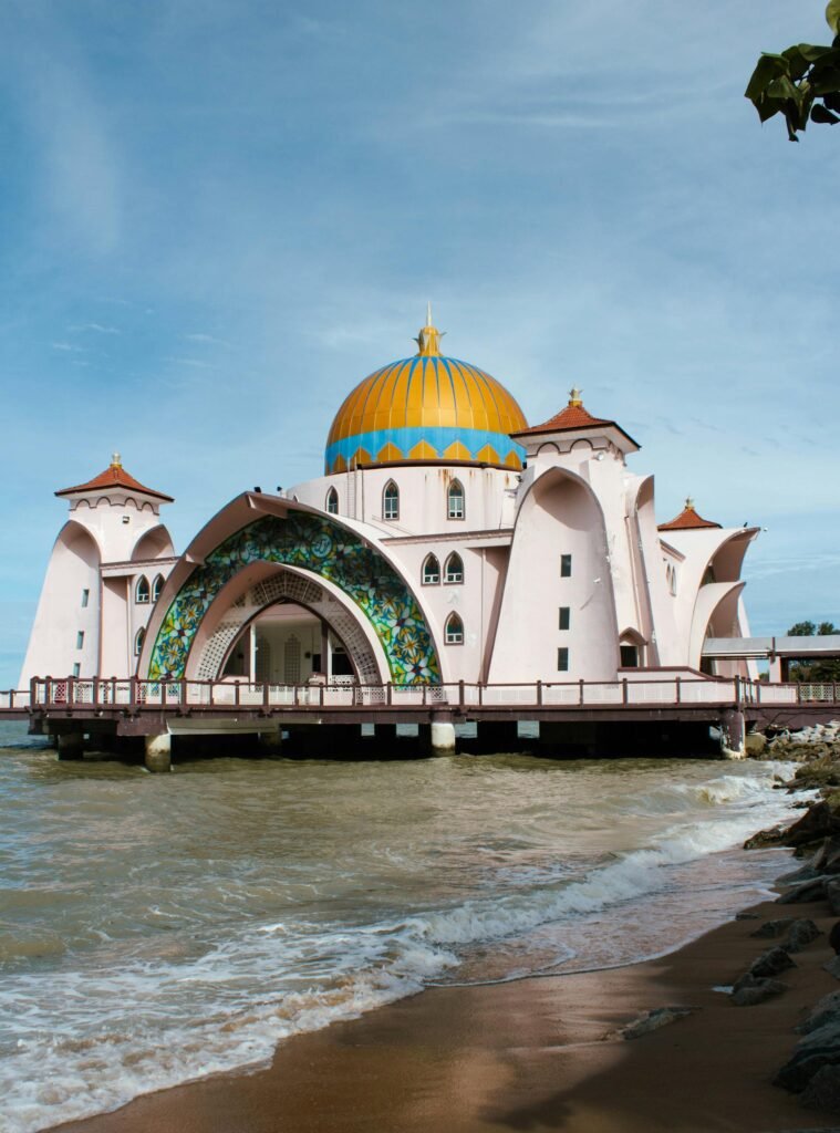 Stunning Malaysian mosque with a colorful dome by the sea — Victorian-Moorish-Malay architectural fusion characteristic of Johor's mosque heritage