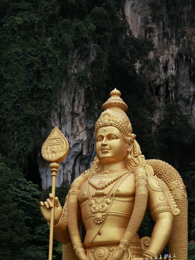 Close-up of the majestic golden Lord Murugan statue at Batu Caves, the centerpiece of Kuala Lumpur's most photographed Hindu pilgrimage site
