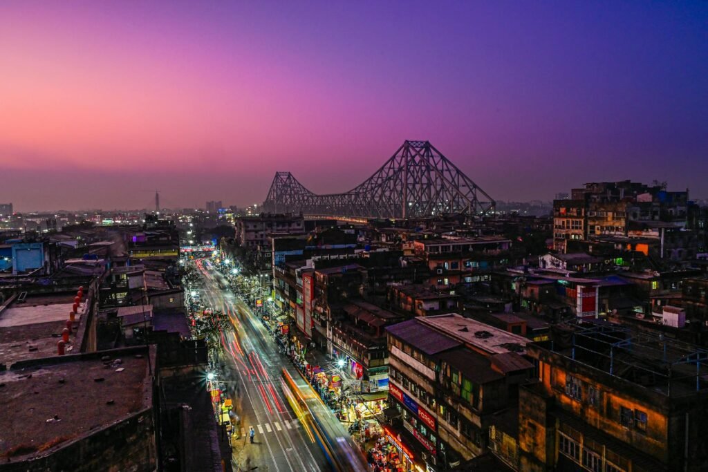 Stunning night view of the iconic Howrah Bridge in Kolkata — the 1943 cantilever bridge spanning the Hooghly River, one of the world's busiest with over 100,000 daily vehicle crossings