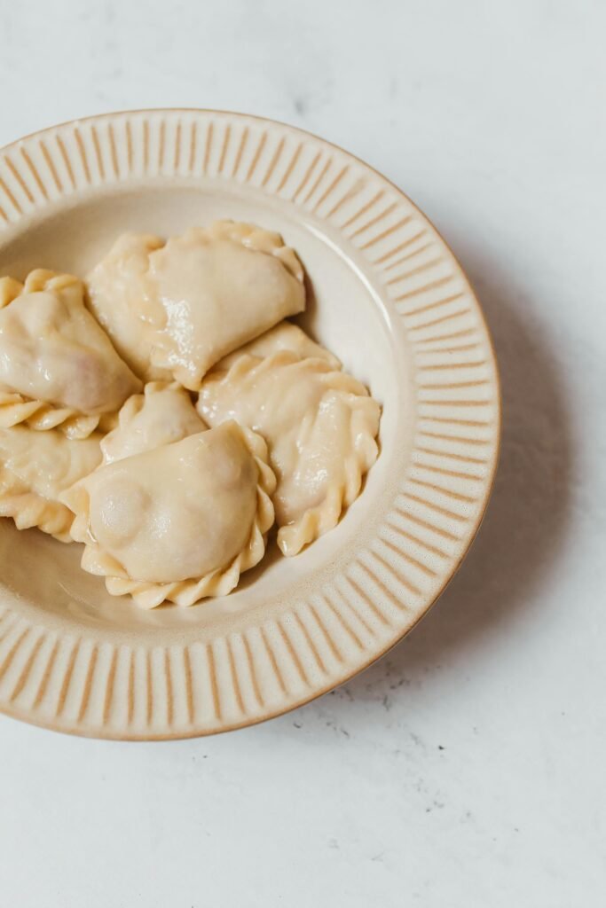 Delicious traditional Polish pierogi dumplings served on a ceramic plate