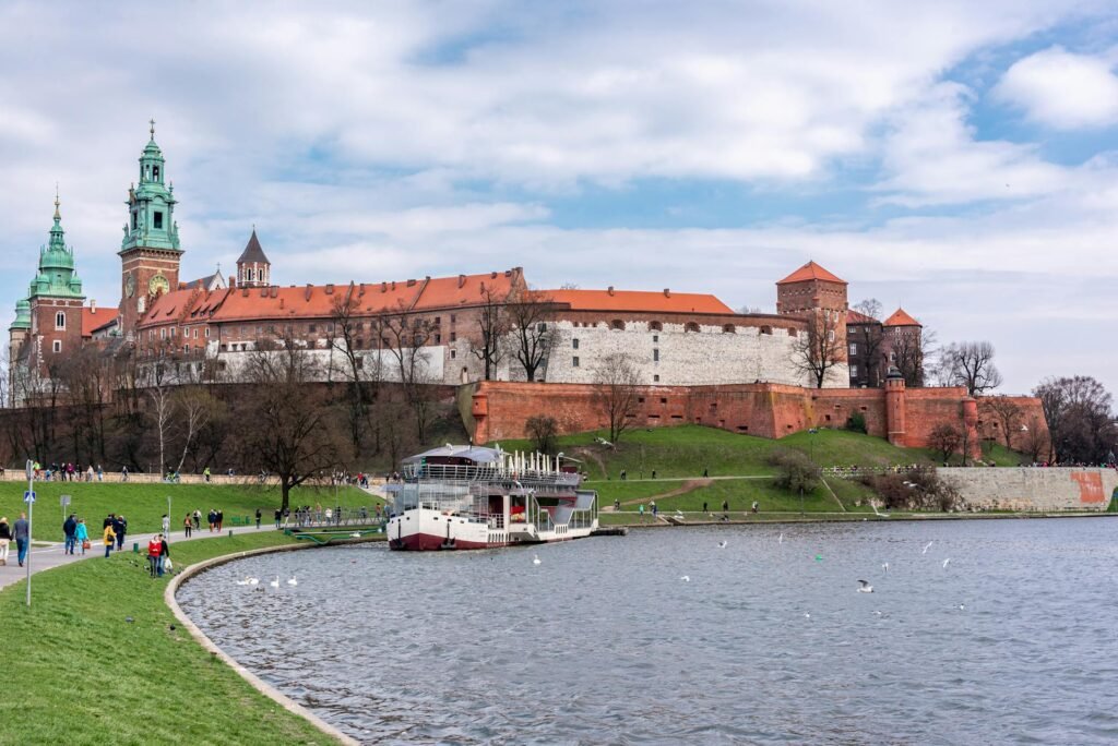 Scenic view of Wawel Castle in Krakow with boats on the Vistula River