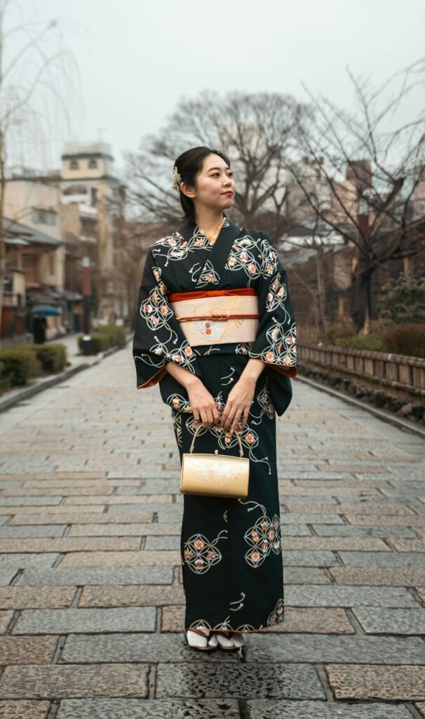 Traditional kimono-clad woman on a Kyoto street — the living continuation of the city's 1,000-year imperial heritage and the visual symbol of traditional Japanese culture preserved in Kyoto's historic districts