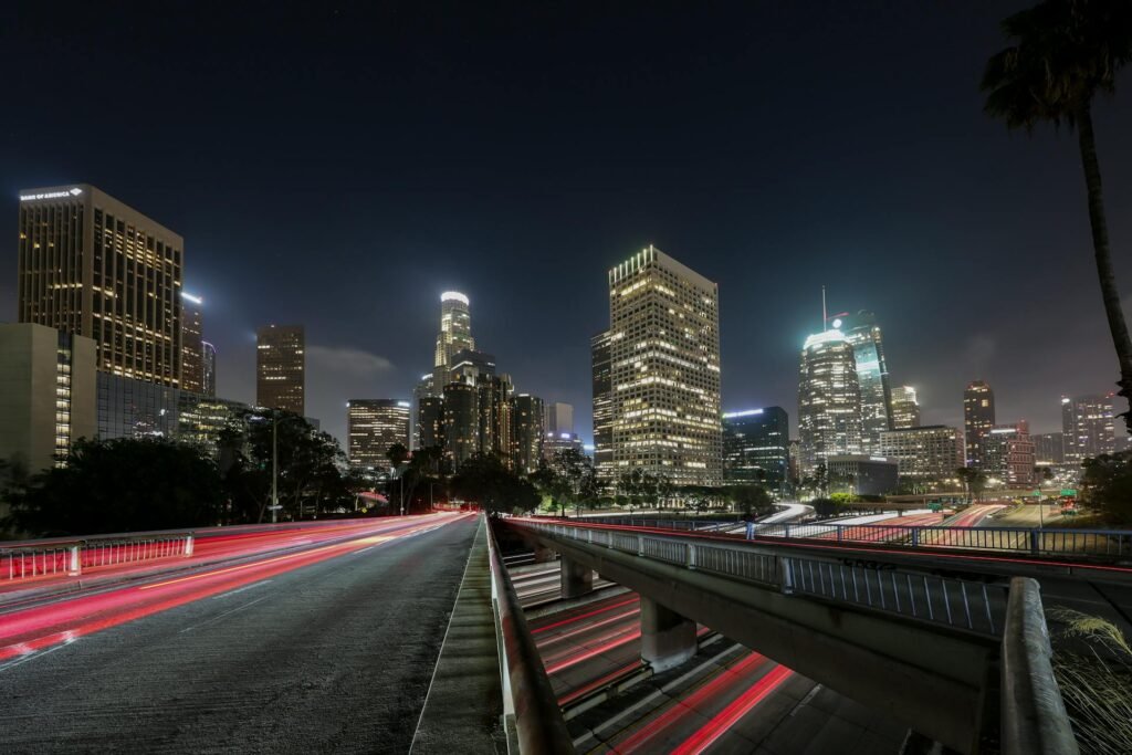 Night cityscape of downtown Los Angeles skyscrapers in long-exposure with light trails