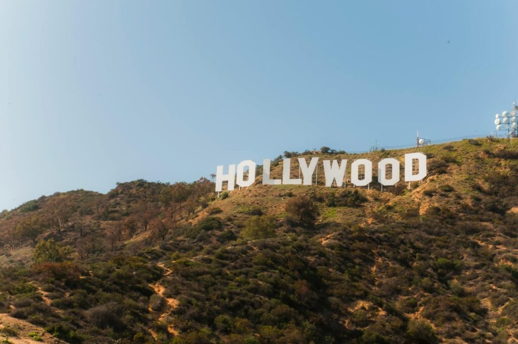The iconic Hollywood Sign on Mount Lee with Los Angeles in the foreground under clear blue California sky