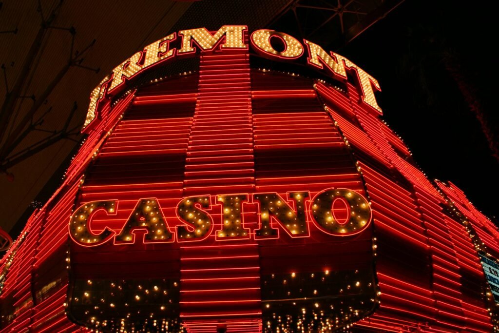 Bright neon lights of Fremont Casino in Las Vegas at night, showcasing vibrant red and yellow tones