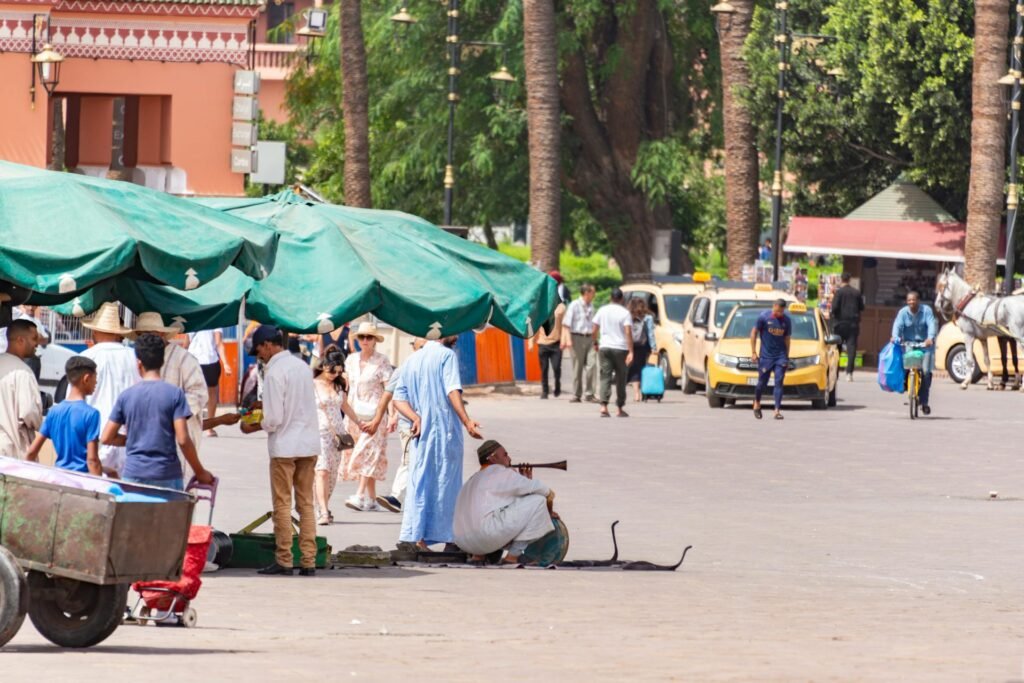 The bustling Jemaa el-Fnaa square in Marrakech — UNESCO-designated Masterpiece of the Oral and Intangible Heritage of Humanity, with crowds, performers, and food stalls at the heart of the medina