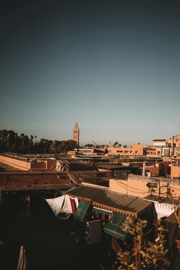 Stunning view of the Marrakech cityscape with the 12th-century Koutoubia Mosque's 77-meter minaret rising above the ochre walls of the historic medina