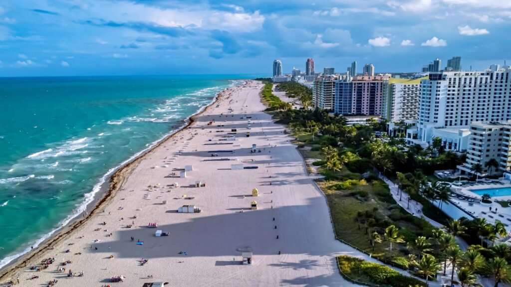 Aerial shot of Miami Beach showcasing the coastline, city skyline, and vibrant sea — South Beach district view