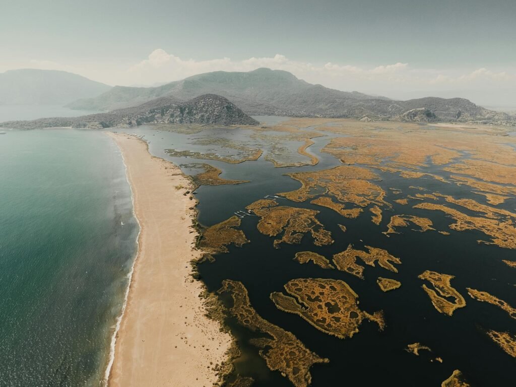 Aerial view of Dalyan's İztuzu Turtle Beach in Muğla Province — the distinctive sandbar separating the Dalyan River reed beds from the open Mediterranean, a protected loggerhead turtle nesting site