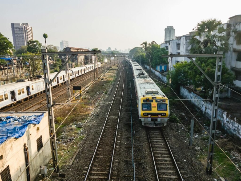 Aerial view of trains on tracks at a Mumbai railway station, part of the city's 302 km suburban network