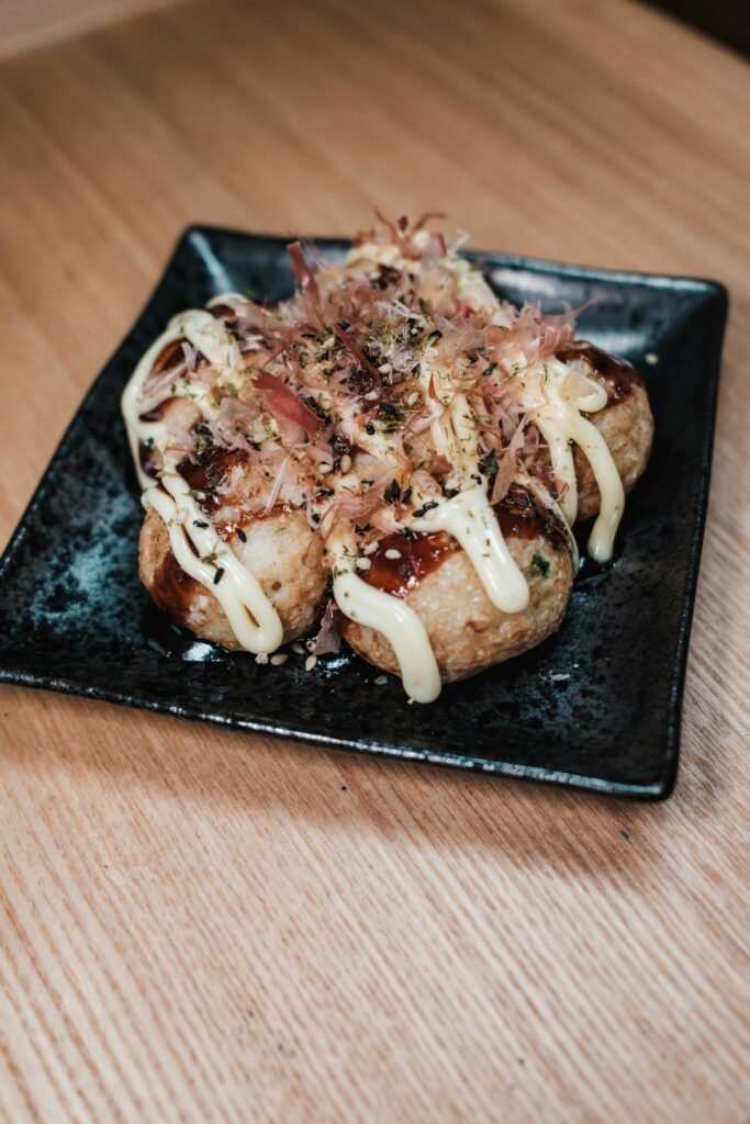 Traditional Japanese takoyaki balls topped with mayonnaise and bonito flakes — Osaka's signature street food