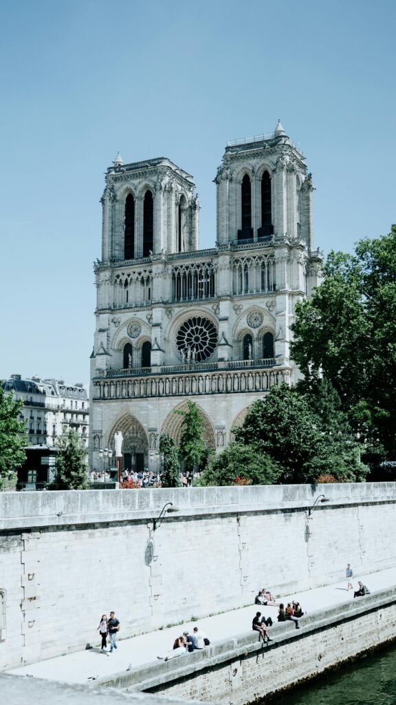 The Gothic facade of Notre-Dame Cathedral in Paris on a clear sunny day