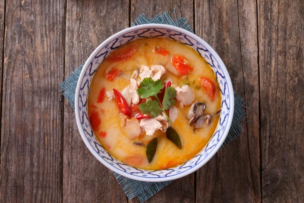 Authentic Thai Tom Kha Gai soup with chicken, coconut milk, lemongrass, and vegetables — classic Thai cuisine