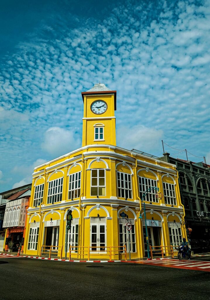 Stunning yellow Sino-Portuguese colonial building with clock tower in Phuket Old Town's UNESCO heritage district