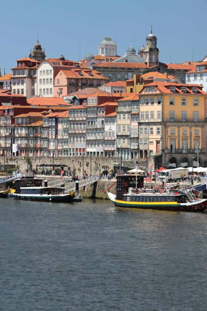 Traditional Port wine boats (rabelos) moored at the Porto waterfront — the colorful Ribeira riverfront where the city's centuries of Atlantic trade and Port wine culture remain visible