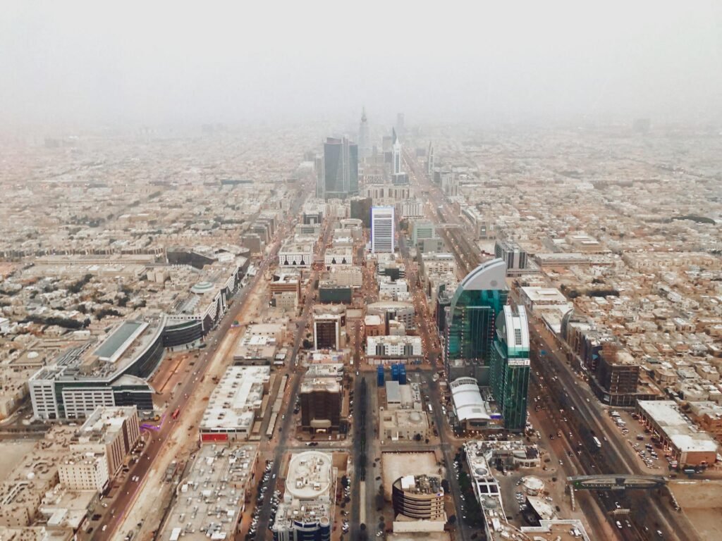 Aerial photograph of Riyadh's modern cityscape with iconic skyscrapers — the rapid transformation of the Saudi capital under Vision 2030 visible against the desert plateau